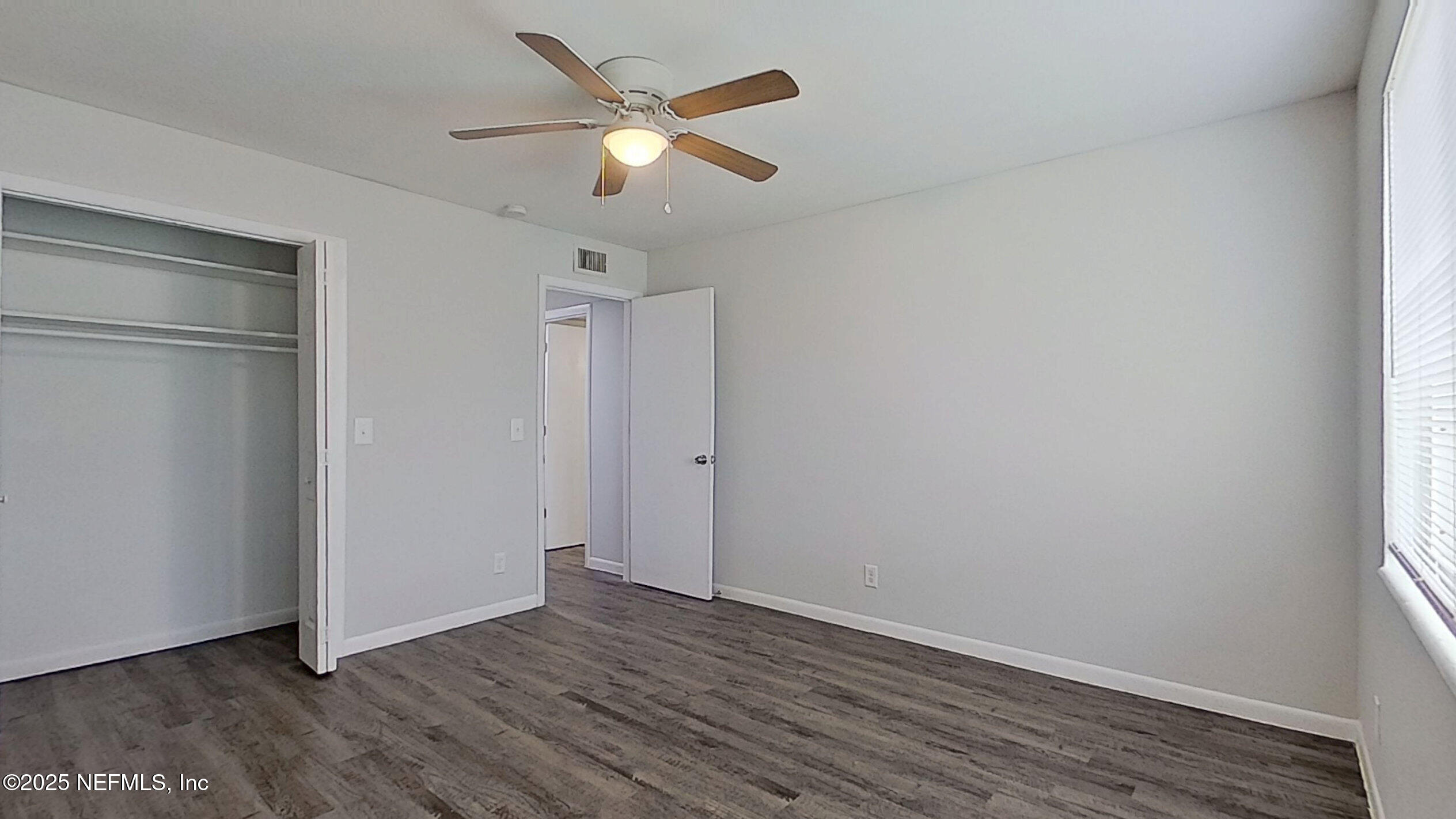 2216 Spring Park Road, Unit 8 Jacksonville, FL 32207 - Photo 20 of 32 an empty room with wooden floor and a ceiling fan