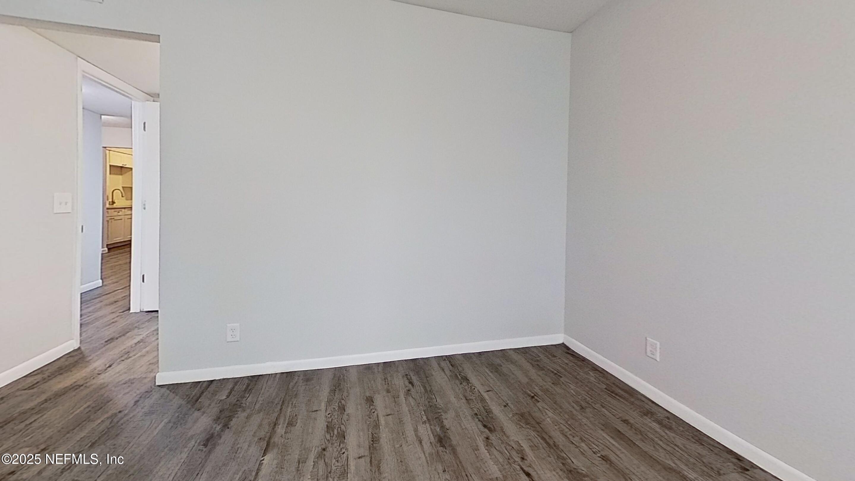 2216 Spring Park Road, Unit 8 Jacksonville, FL 32207 - Photo 25 of 32 a view of an empty room with wooden floor and a window