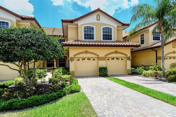 a front view of a house with a yard and garage