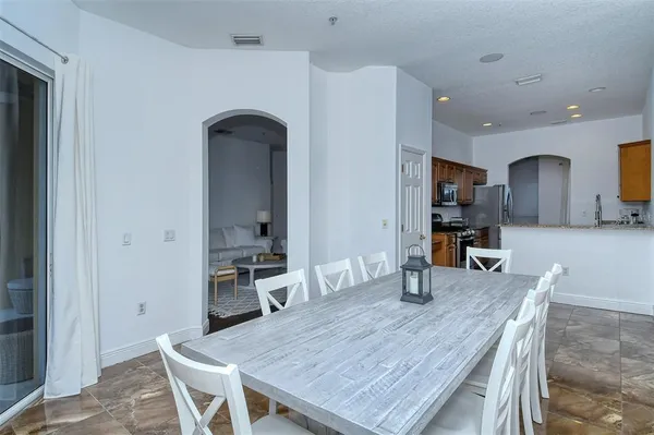 a kitchen with granite countertop stainless steel appliances a stove microwave and sink