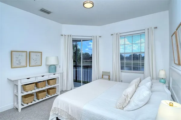 a bedroom with two beds and painting on the wall