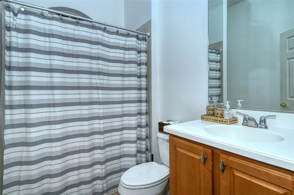 8363 Miramar Way, Unit 203 Lakewood Ranch, FL 34202 - Photo 29 of 73 a bathroom with a sink a toilet and shower curtain
