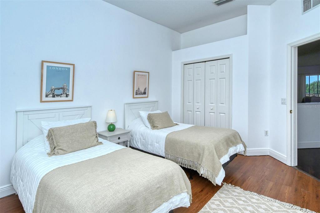 8363 Miramar Way, Unit 203 Lakewood Ranch, FL 34202 - Photo 32 of 73 a bedroom with two beds and painting on the wall