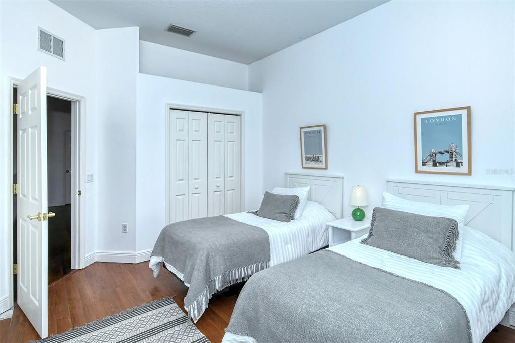 8363 Miramar Way, Unit 203 Lakewood Ranch, FL 34202 - Photo 34 of 73 a bedroom with two beds and a lamp