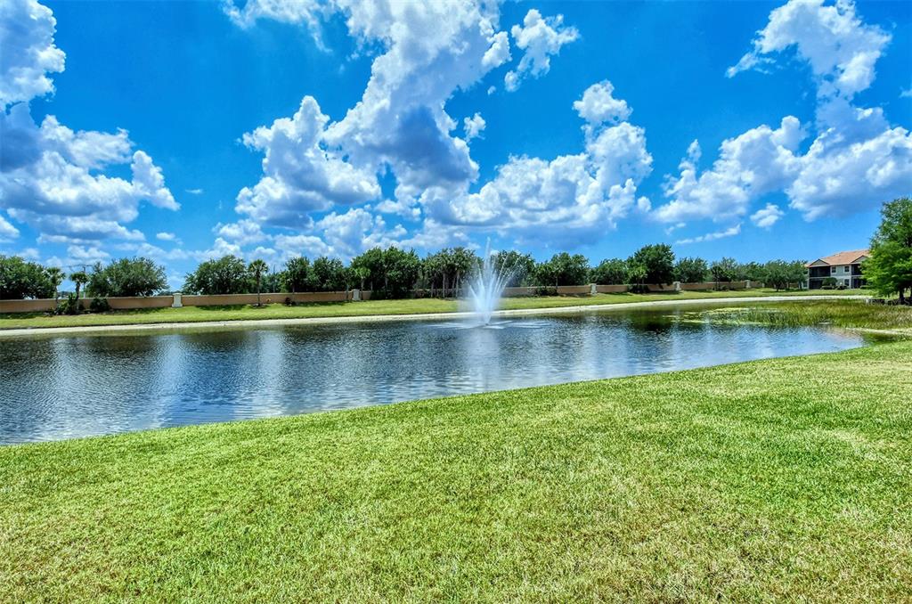 8363 Miramar Way, Unit 203 Lakewood Ranch, FL 34202 - Photo 36 of 73 a view of a lake with a house in the background