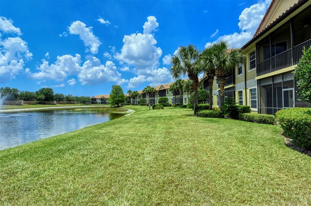 8363 Miramar Way, Unit 203 Lakewood Ranch, FL 34202 - Photo 39 of 73 a view of a lake with a house in the background