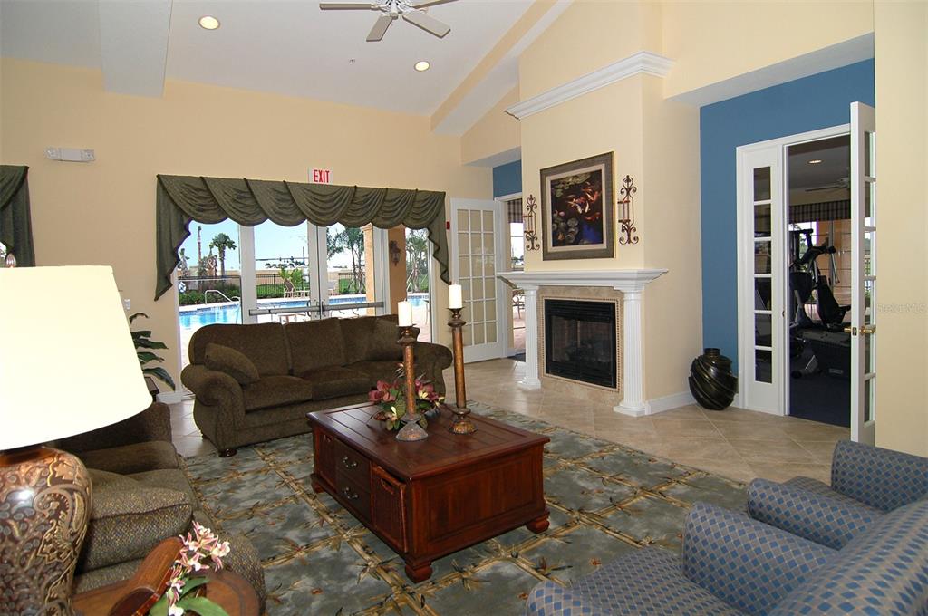 8363 Miramar Way, Unit 203 Lakewood Ranch, FL 34202 - Photo 52 of 73 a living room with furniture fireplace and flat screen tv