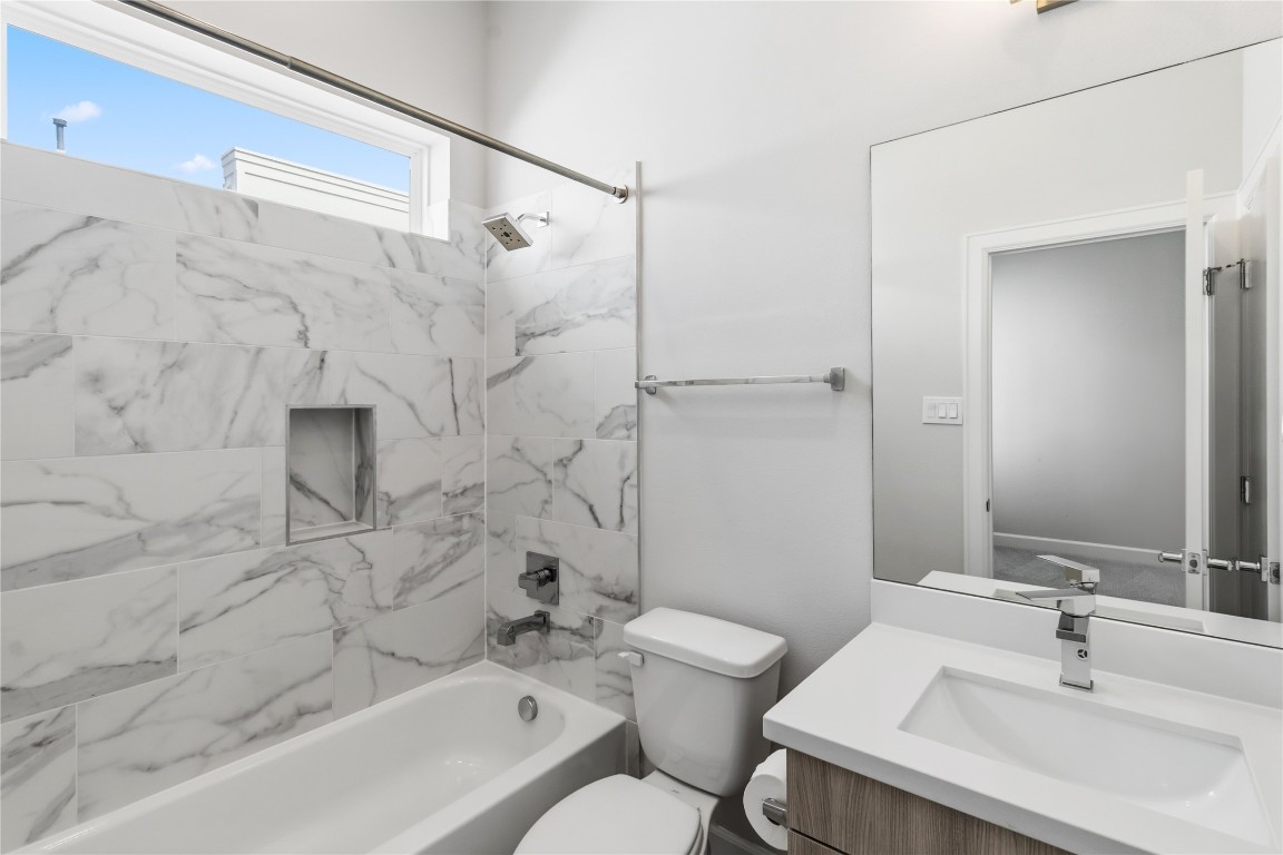 1509 Elgin Street Houston, TX 77004 - Photo 29 of 34 Luxurious ensuite bathroom for the third bedroom, featuring elegant marble tiles and modern fixtures and walk-in closet