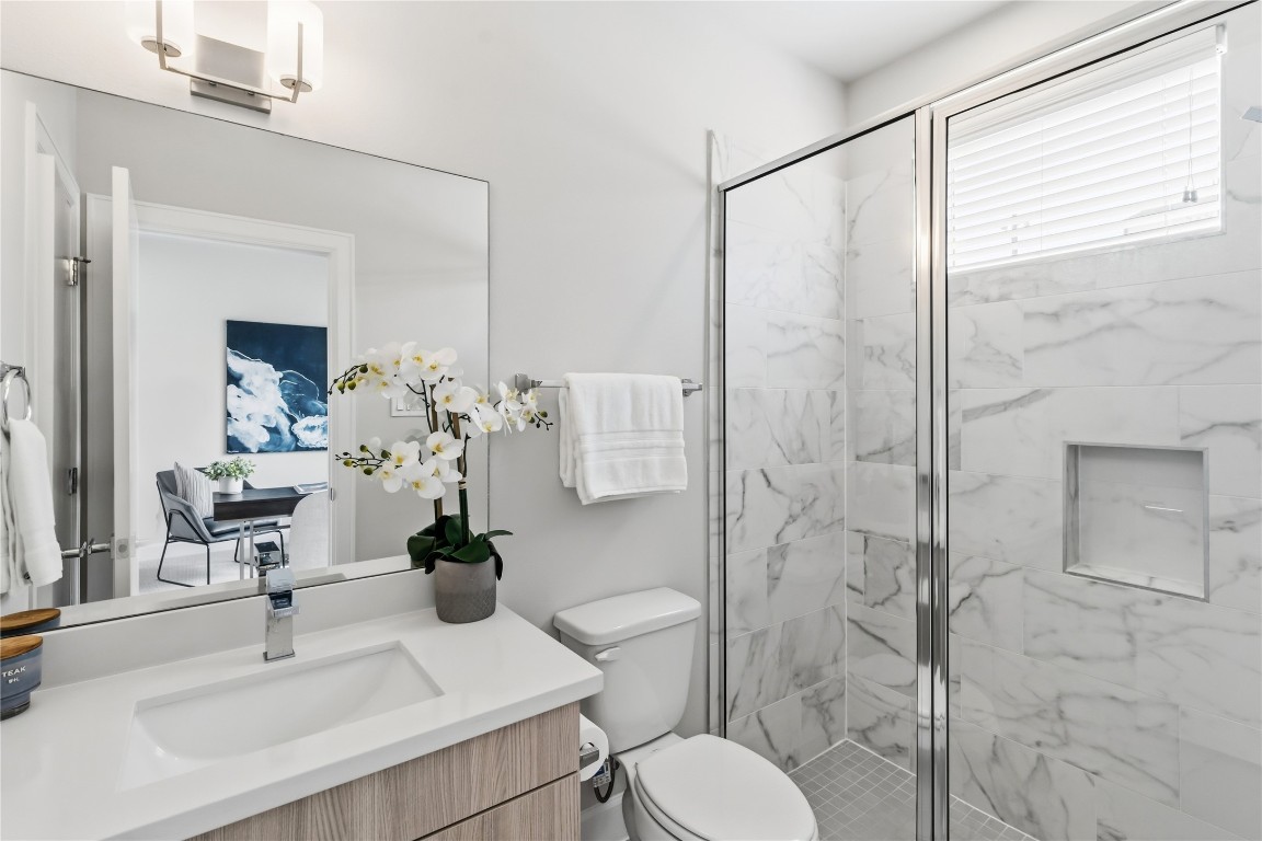 1509 Elgin Street Houston, TX 77004 - Photo 5 of 34 Stylish first-floor bathroom with a stand-up shower and convenient walk-in closet access.