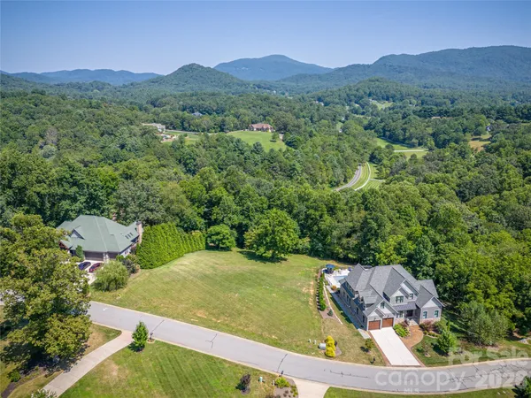 an aerial view of a house with yard