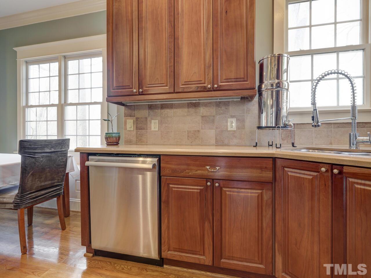 2917 Debra Drive Raleigh, NC 27607 - Photo 18 of 52 a kitchen with granite countertop wooden cabinets a sink and appliances