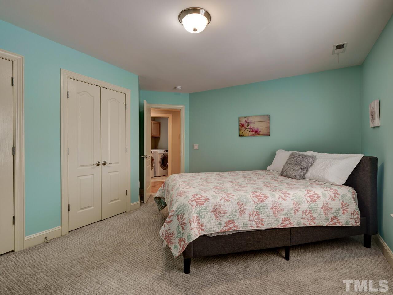 2917 Debra Drive Raleigh, NC 27607 - Photo 35 of 52 a bedroom with a bed and a lamp