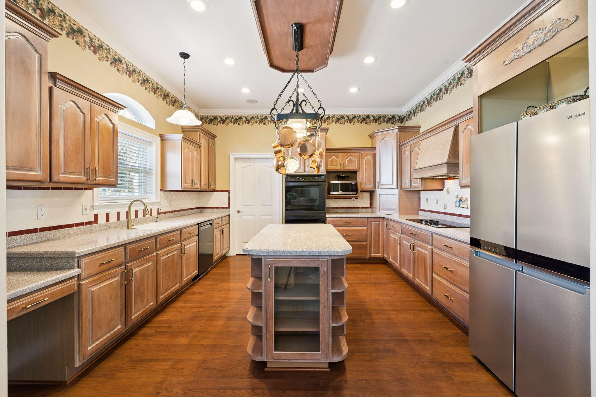 111 Snowdrift Road Miramar Beach, FL 32550 - Photo 17 of 32 a large kitchen with stainless steel appliances kitchen island granite countertop a stove a sink dishwasher and a refrigerator with wooden floor