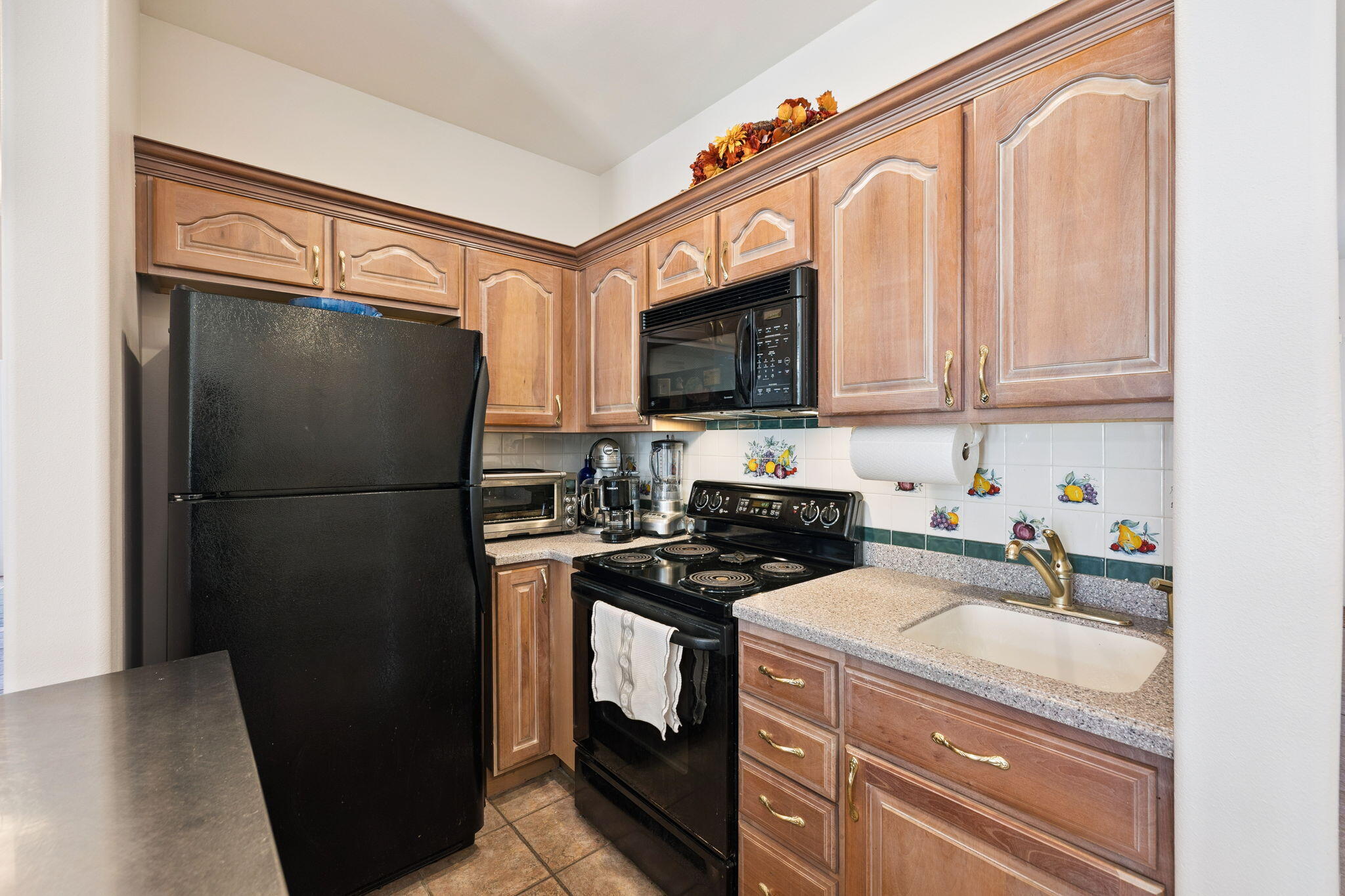 111 Snowdrift Road Miramar Beach, FL 32550 - Photo 9 of 32 a kitchen with a refrigerator and a sink