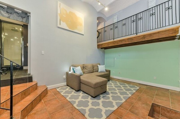 330 E Street, Unit 1 Boston, MA 02127 - Photo 13 of 24 a living room with furniture and a flat screen tv