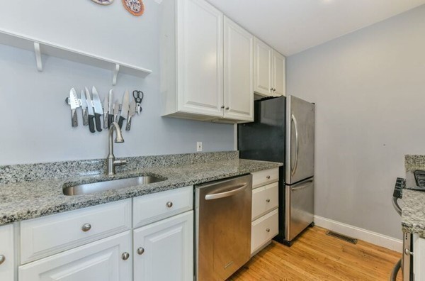 330 E Street, Unit 1 Boston, MA 02127 - Photo 15 of 24 a kitchen with stainless steel appliances granite countertop a refrigerator and a sink