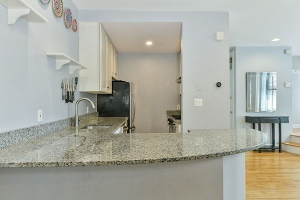 330 E Street, Unit 1 Boston, MA 02127 - Photo 16 of 24 a kitchen with stainless steel appliances granite countertop a sink a stove and a refrigerator