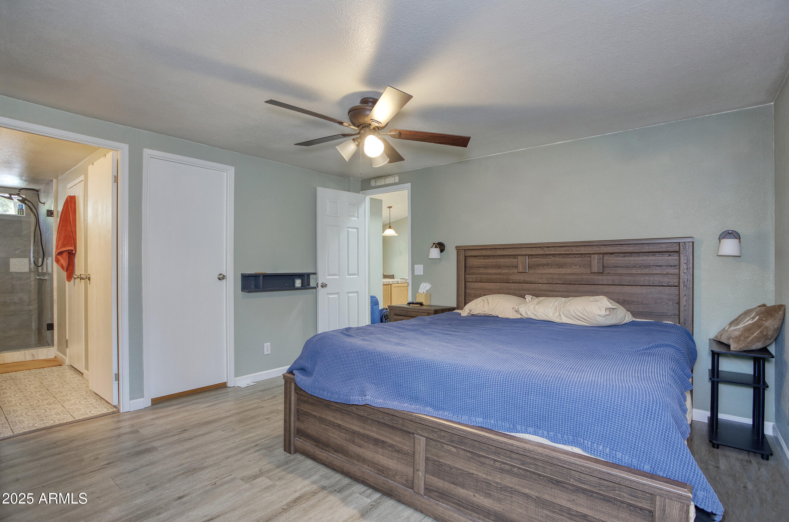 17090 Iron Springs Road Munds Park, AZ 86017 - Photo 28 of 68 a bedroom with a bed and a chandelier