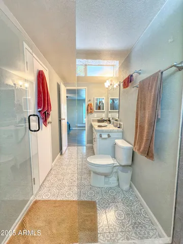 a bathroom with a toilet and a shower