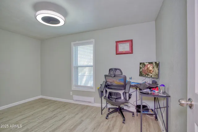 a front view of a house with a yard and large tree