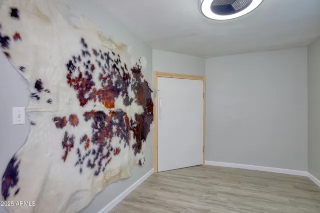 a view of a house with wooden fence and a tree