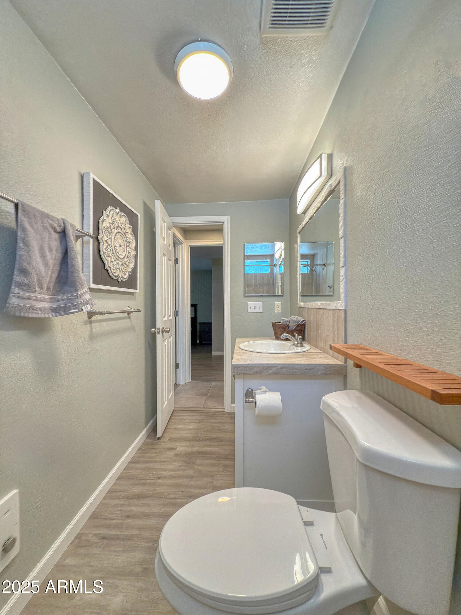 17090 Iron Springs Road Munds Park, AZ 86017 - Photo 47 of 68 a bathroom with a toilet sink and mirror