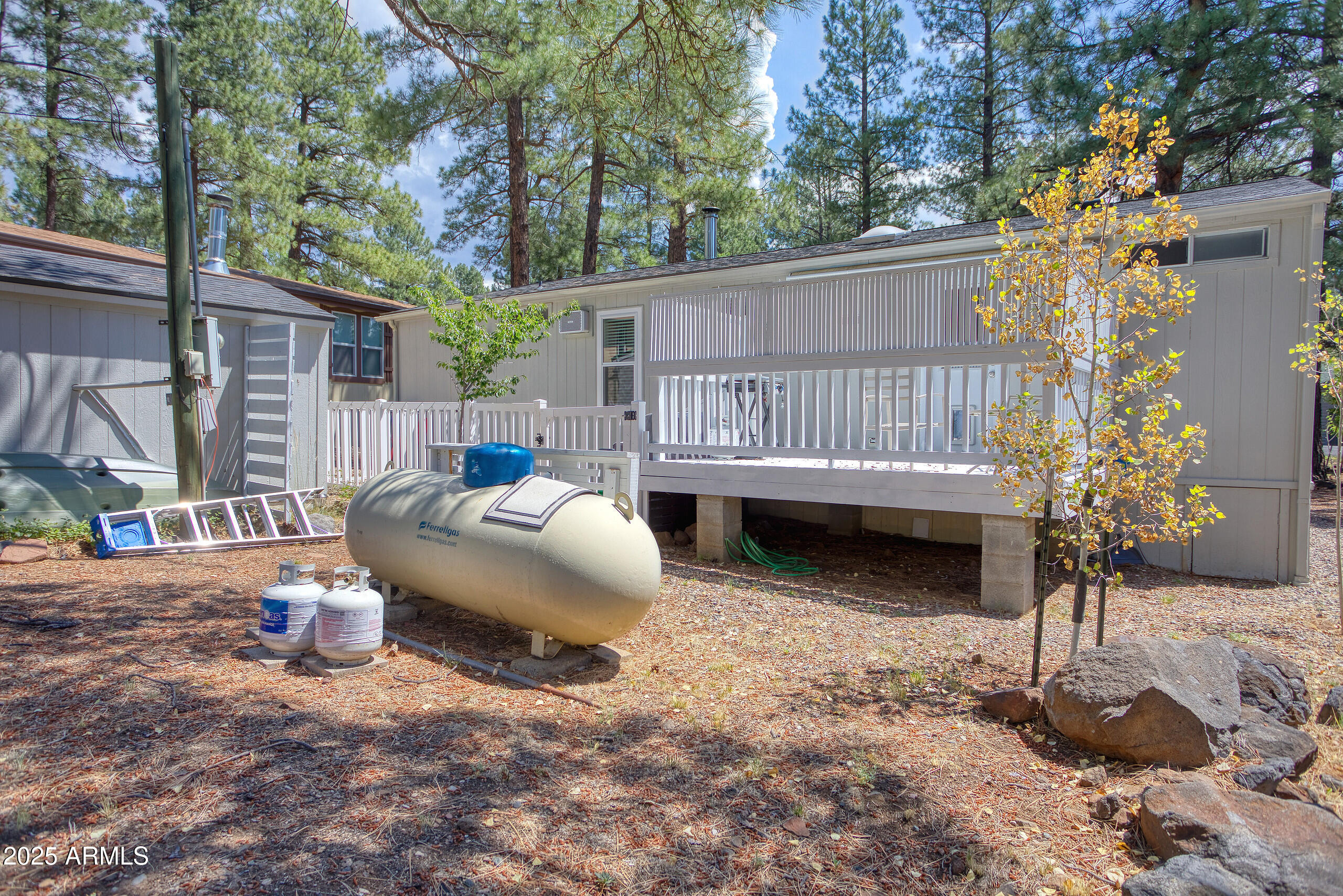 17090 Iron Springs Road Munds Park, AZ 86017 - Photo 62 of 68 a view of a backyard with a patio and wooden fence