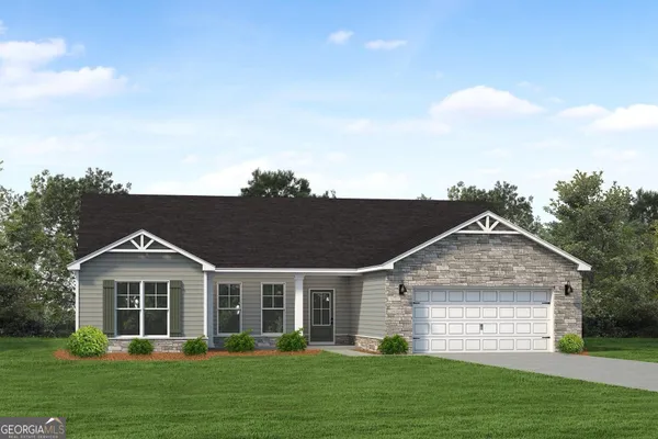 a front view of a house with a yard and trees