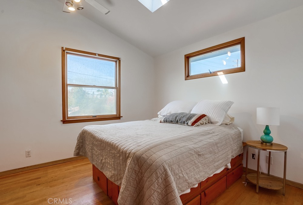 711 Marco Place Venice, CA 90291 - Photo 11 of 14 a bedroom with a bed and wooden floor