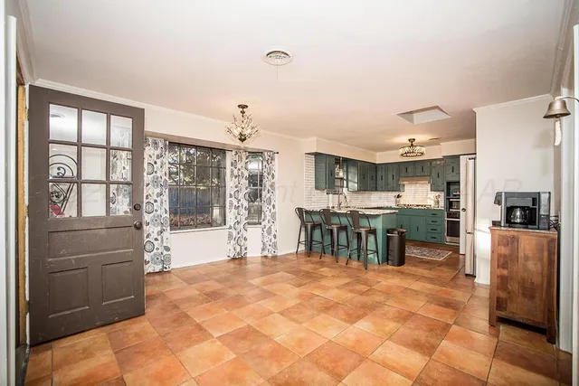 a bedroom with a bed and a mirror on the dresser