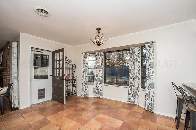 a view of a patio with couches chairs and a flat screen tv