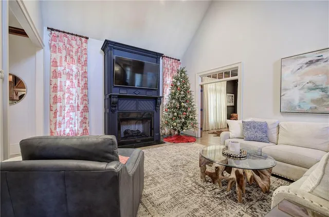 a living room with furniture a flat screen tv and a fireplace