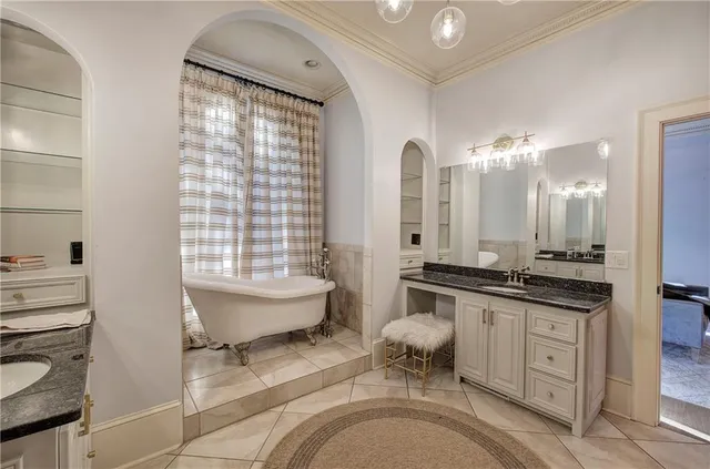 a bathroom with a granite countertop sink a toilet a mirror and shower