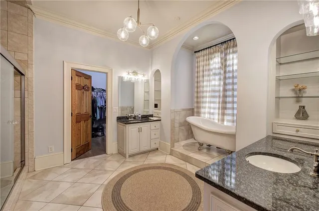 a kitchen with stainless steel appliances granite countertop a stove a refrigerator and a sink with wooden cabinets