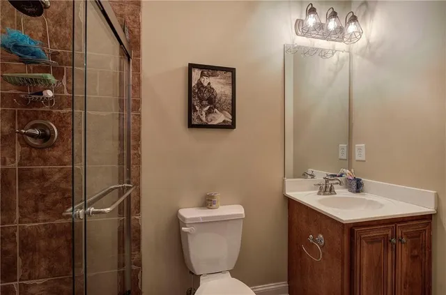 a spacious bedroom with a bed and a chandelier