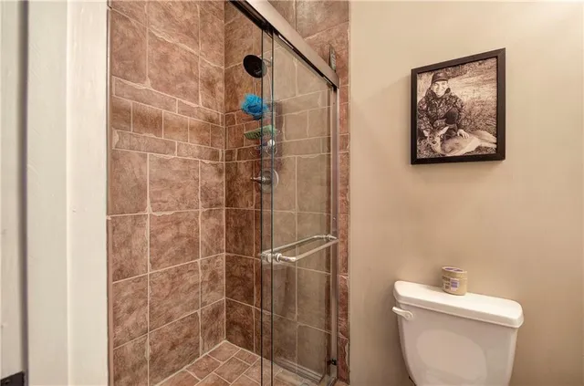 a spacious bathroom with a double vanity sink a mirror and a shower