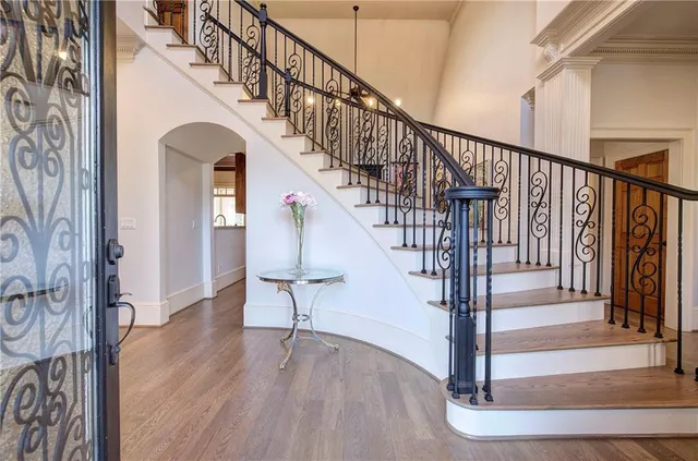 a view of entryway and hall with wooden floor