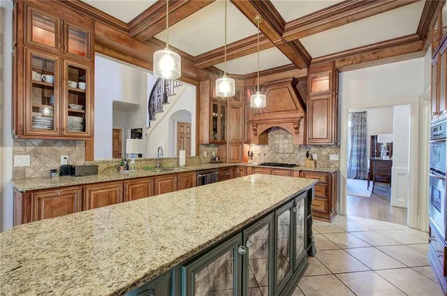a kitchen with a sink a stove and cabinets