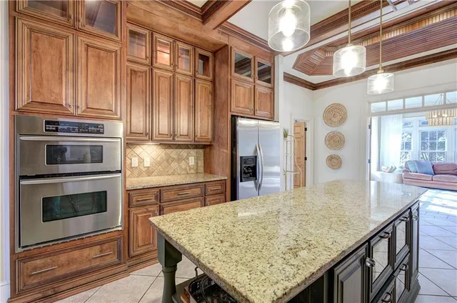 a kitchen with stainless steel appliances granite countertop a stove refrigerator and microwave