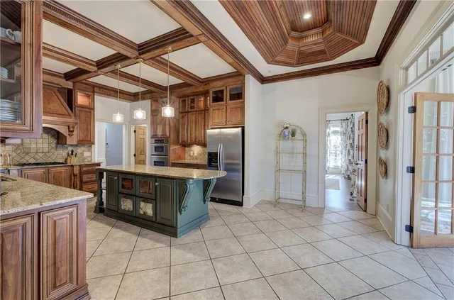 a kitchen with stainless steel appliances granite countertop a refrigerator and a sink