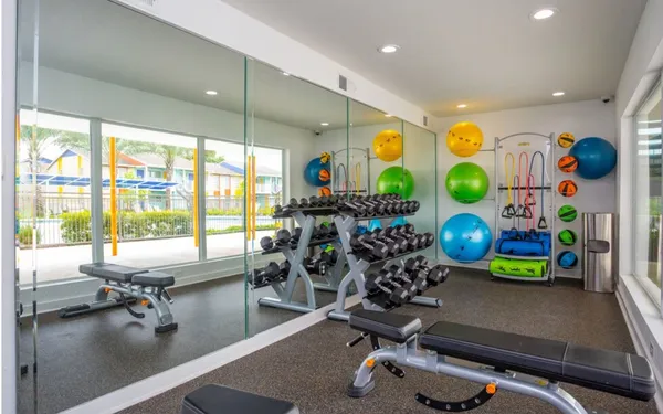 a room with gym equipment and a large window