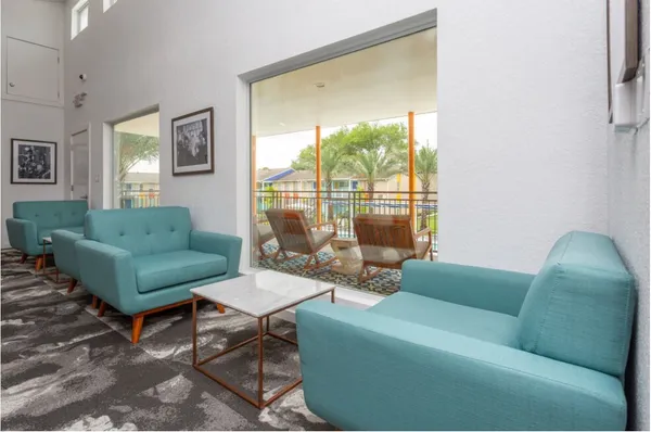 a living room with furniture and a large window