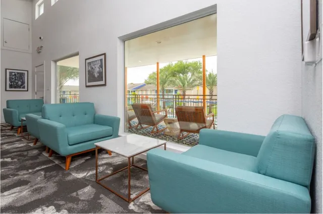 a living room with furniture and a large window