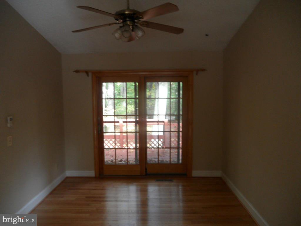 9485 Good Lion Road Columbia, MD 21045 - Photo 12 of 20 a view of an empty room with wooden floor and a window