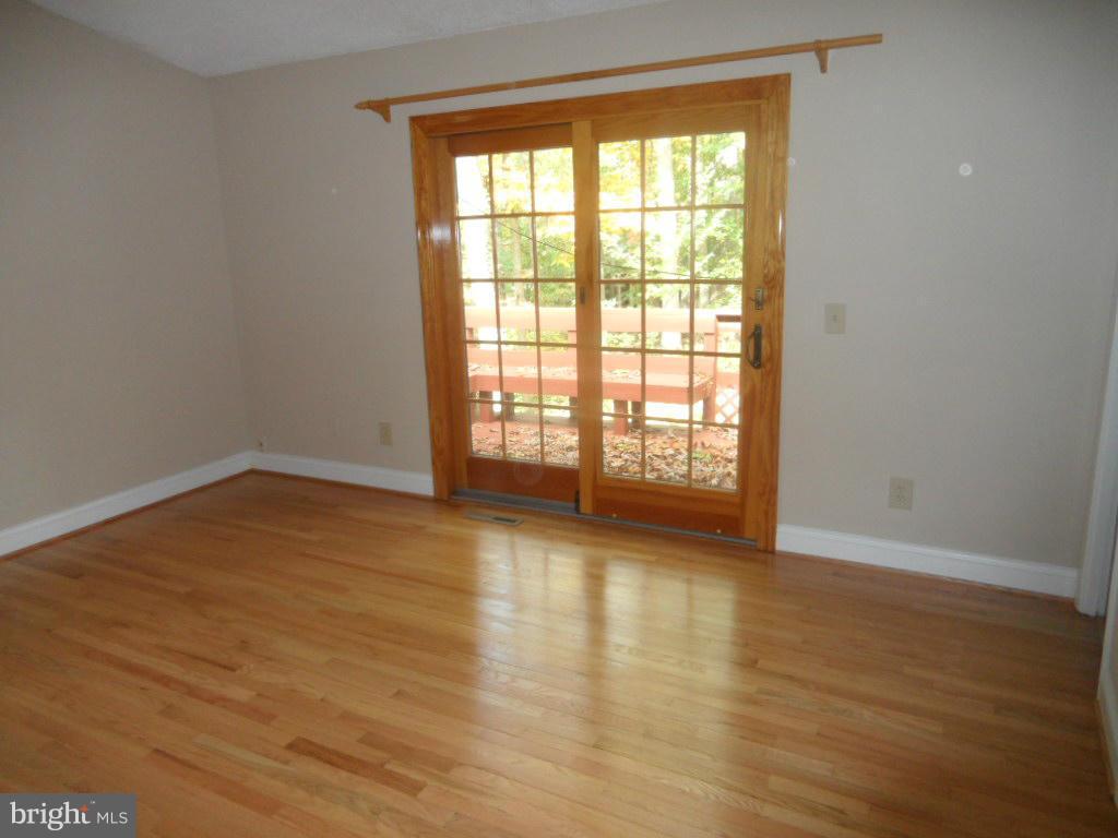9485 Good Lion Road Columbia, MD 21045 - Photo 13 of 20 a view of an empty room with wooden floor and a window