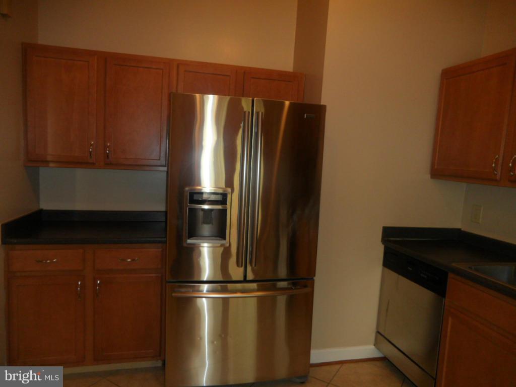 9485 Good Lion Road Columbia, MD 21045 - Photo 14 of 20 a metallic refrigerator freezer sitting in a kitchen