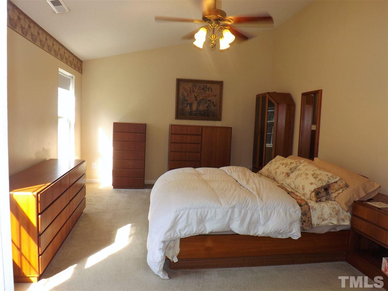 4904 Marathon Lane Raleigh, NC 27616 - Photo 11 of 25 a bedroom with a bed and wooden floor