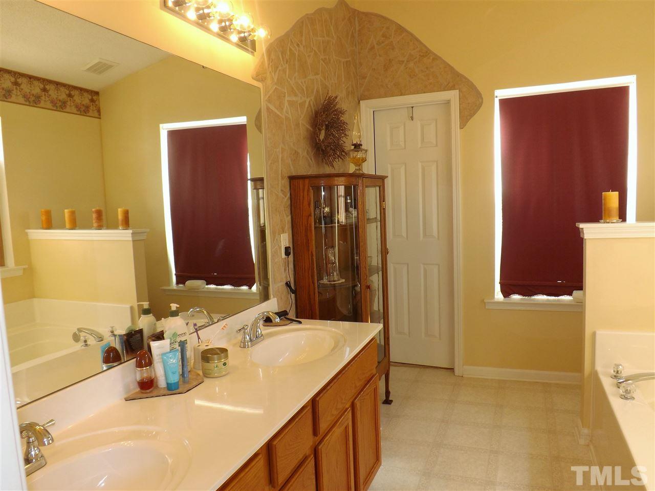 4904 Marathon Lane Raleigh, NC 27616 - Photo 12 of 25 a bathroom with a sink vanity and a mirror