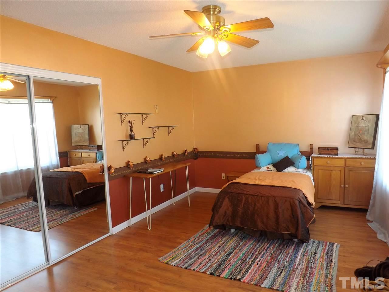 4904 Marathon Lane Raleigh, NC 27616 - Photo 13 of 25 a bedroom with furniture and wooden floor