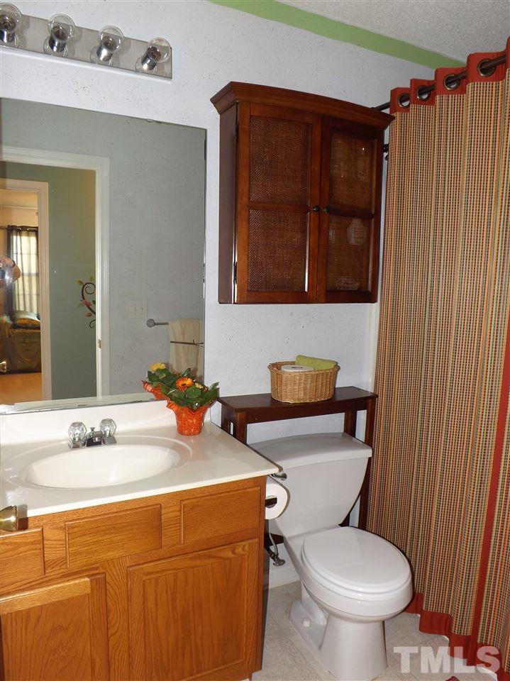4904 Marathon Lane Raleigh, NC 27616 - Photo 15 of 25 a bathroom with a toilet a sink and a mirror